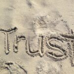 Person trusting and surrendering to God during cancer finding courage through faith